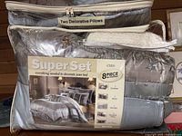 Front of sealed bedding package showing Super Set Cleo label and contents list