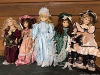 Group shot of five porcelain dolls standing side by side