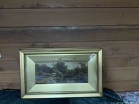 Front view showing landscape artwork, gold-tone beaded frame and glass