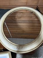 Front view showing entire oval mirror with off-white frame