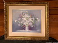 Front view of framed floral oil painting showing artwork, frame, and signature