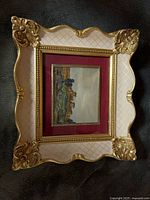 Front view showing ornate frame, mat and painting