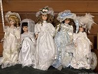 Group shot of five porcelain dolls standing side by side