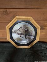 Front view of framed plate showing winter scene artwork