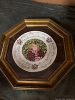 Front view of framed plate showing artwork and frame details