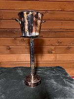 Full view of bucket mounted on tall pedestal stand