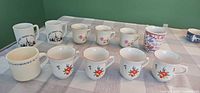 All 11 mugs grouped on table showing patterns and quantity