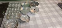 Overview of all ten aluminum bakeware pieces laid out on table