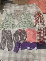 All twelve clothing items laid out on blanket