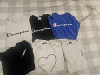 All six T-shirts laid out showing front graphics