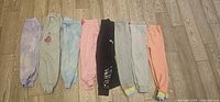 All seven jogger sweatpants laid flat side by side for full lot overview
