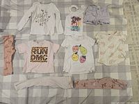 All nine clothing items laid out on checkered surface