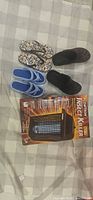 Overall lot showing insect killer light box and three pairs of slippers