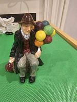Front view showing seated man with balloons, color and detail visible