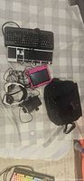Group view of two keyboards, tablet, headset, projector, laptop bag