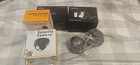 Two sealed Wansview PTZ camera boxes, seven boxed dummy cameras, one dummy camera shown in wrapping