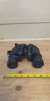 Top view of Crestline 7x35 binoculars with tape measure for scale