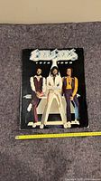 Front cover of Bee Gees 1979 tour program with full view and measuring tape showing width