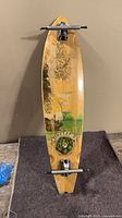 Full view of Sector 9 longboard deck with trucks but no wheels