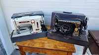 Singer and Arrow machines side by side on table