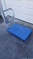 Full view of blue platform cart with fold-down handle
