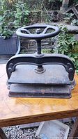 Overall view of cast iron book press showing hand wheel and platens