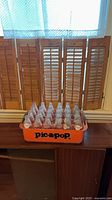 Full view of orange Pic-a-Pop crate filled with bottles