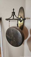 Full view of brass gong on wall mount