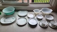 Group shot of all dinnerware and bowls laid out on countertop