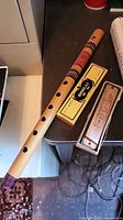 Bamboo flute, harmonica in case, yellow sleeve