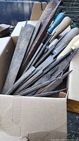 Box containing multiple steel files and rasps with assorted handles