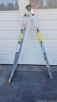 Full view of aluminum articulating ladder in A-frame position