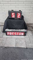 Destination sign box showing PRESTON display beneath numeric box showing 52