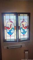 Both stained glass panels side by side showing overall design and size