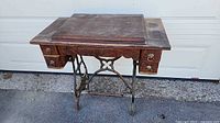 Full view of wooden cabinet on cast iron treadle base