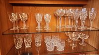 Cabinet view showing full assortment of Waterford crystal pieces on two shelves