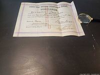 Full view of folded discharge certificate on table
