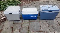 All three coolers side by side on stone patio