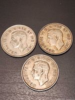 Three George VI Canadian 50-cent coins obverse side