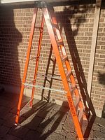 Full view of Featherlite orange fiberglass 8-ft stepladder standing open