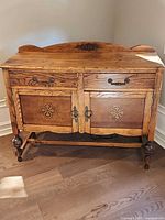 Full view of oak sideboard showing overall design, drawers, doors, backsplash, legs