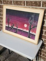 Full view of framed drawing on table