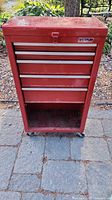 Front view of red Waterloo rolling tool chest, drawers closed, open bottom section visible