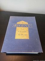 Front cover of blue Regent World Stamp Album