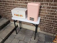 overview of bread box and garbage can on table