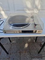Overall view of Sansui P-D30 turntable with dust cover closed on table