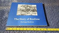 Front cover of blue softcover book titled "The Story of Renfrew"