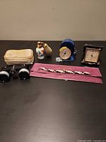 Group shot showing both travel clocks, opera glasses, perfume atomizer, necklace, and zippered case