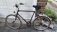 Full left side view of Raleigh Safari bicycle showing frame, wheels, fenders, rack, seat