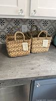 Two Brightroom seagrass baskets on countertop